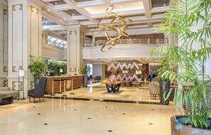A spacious lobby with a reception desk, seating area, and a decorative ceiling sculpture. - InterContinental Santiago by IHG (Santiago)