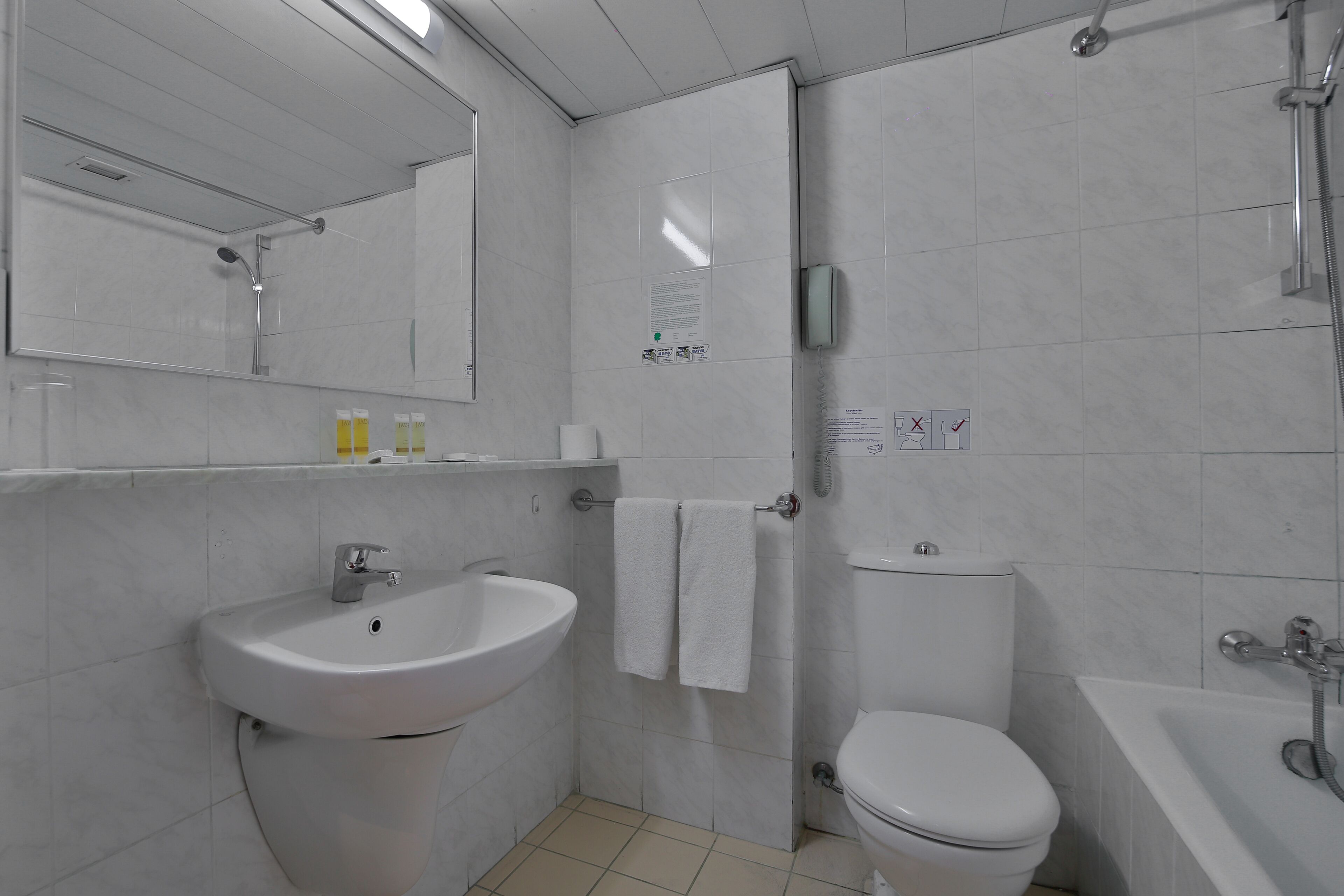 A bathroom with a sink, toilet, and bathtub.