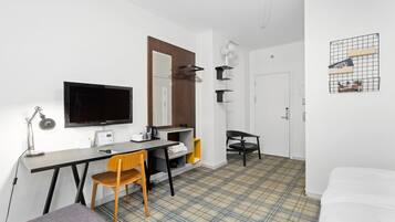A modern room with a desk, chair, and a bed.