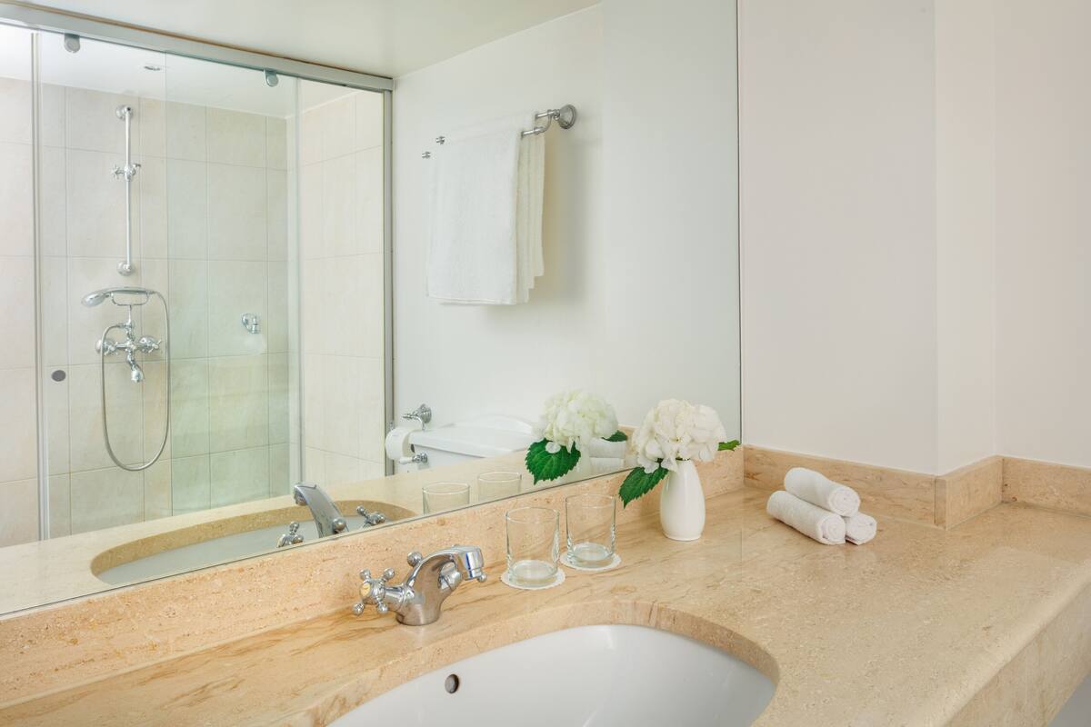 designer toiletries, hair dryer, bathrobes, slippers