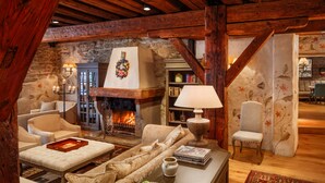 A cozy, rustic living room with a fireplace, wooden beams, and comfortable seating. - Schlössle Hotel - Small Luxury Hotels of the World (Tallinn)