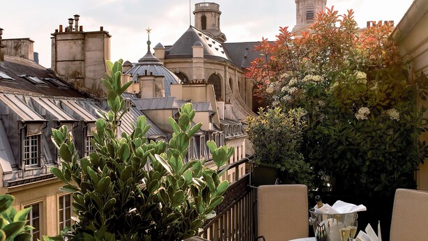 An outdoor seating area with a table, chairs, and a book. - Esprit Saint-Germain (Paris)