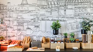A kitchen counter with bread, jars, and plants. - ibis Paris Porte De Montreuil (Paris)