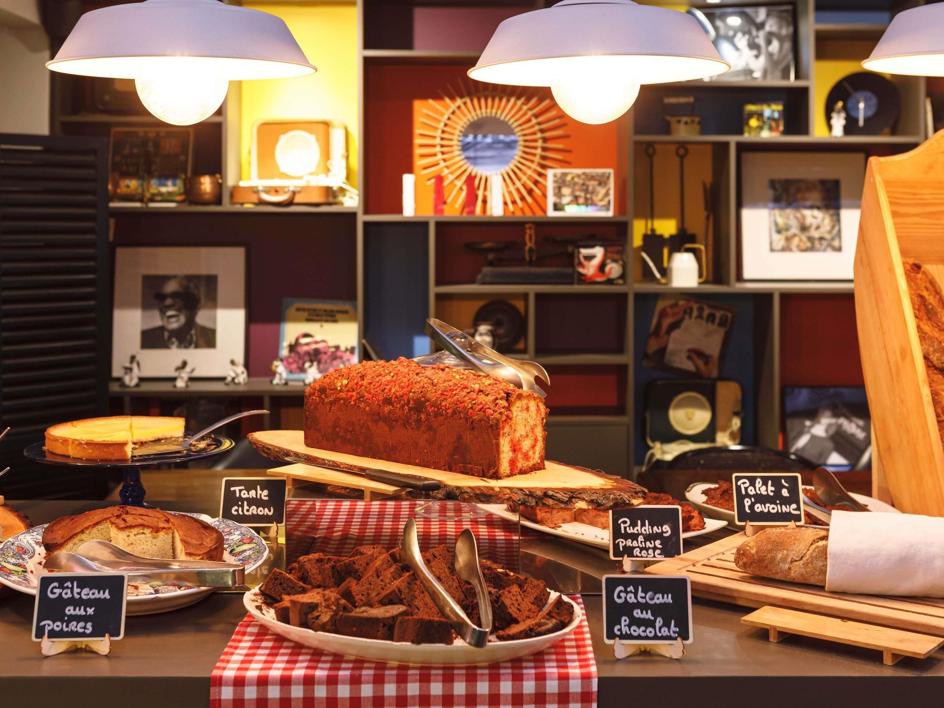 A bakery display with various baked goods and a chalkboard menu.