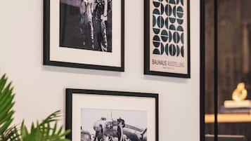 Three framed photographs on a wall, including a Bauhaus exhibition sign.