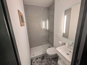 Bathtub, eco-friendly toiletries, hair dryer, towels