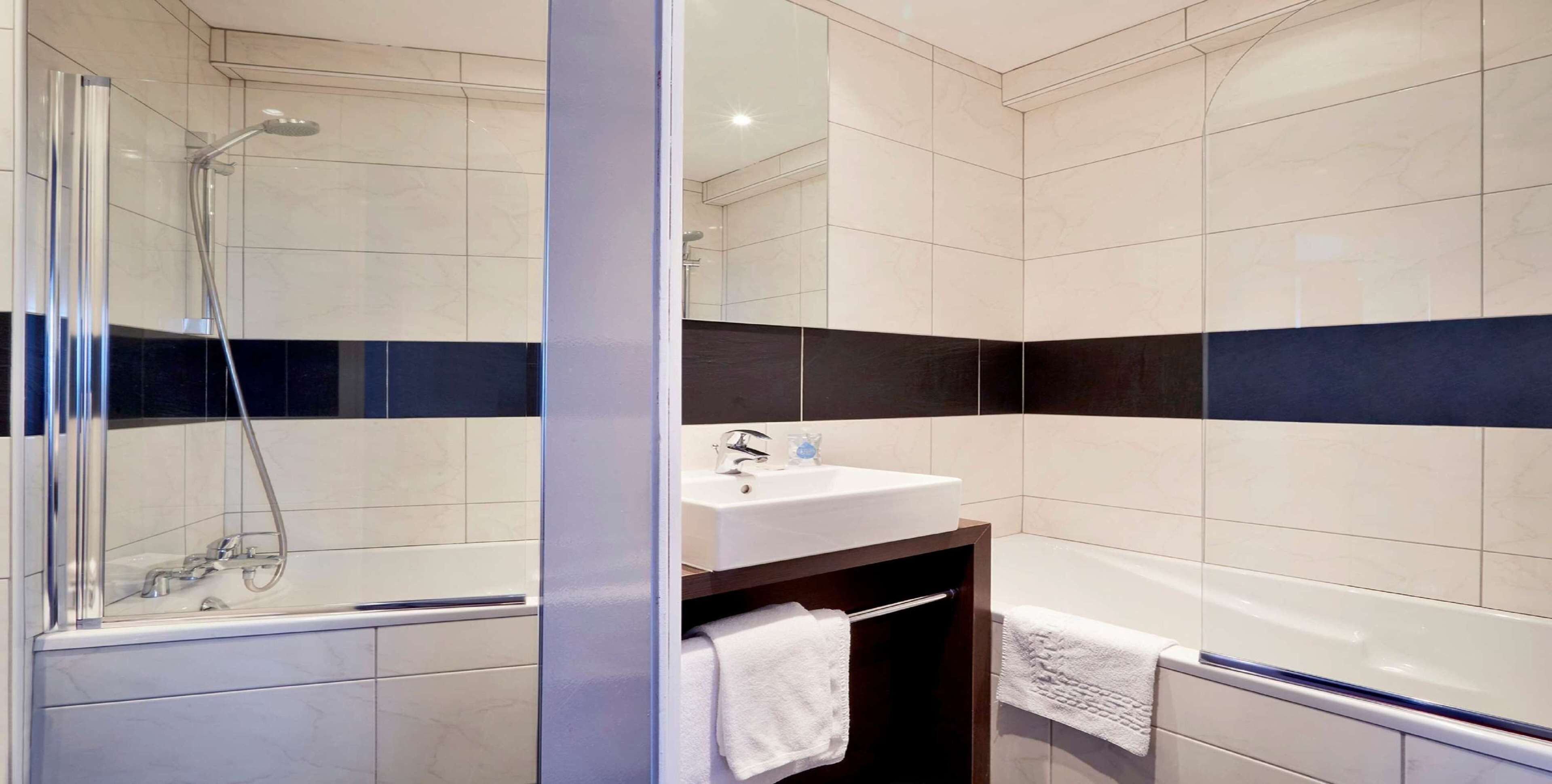 bathtub, eco-friendly toiletries, hair dryer, towels