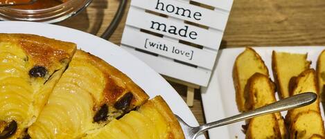 A dessert plate with a slice of pineapple upside-down cake and a sign that reads "home made with love".
