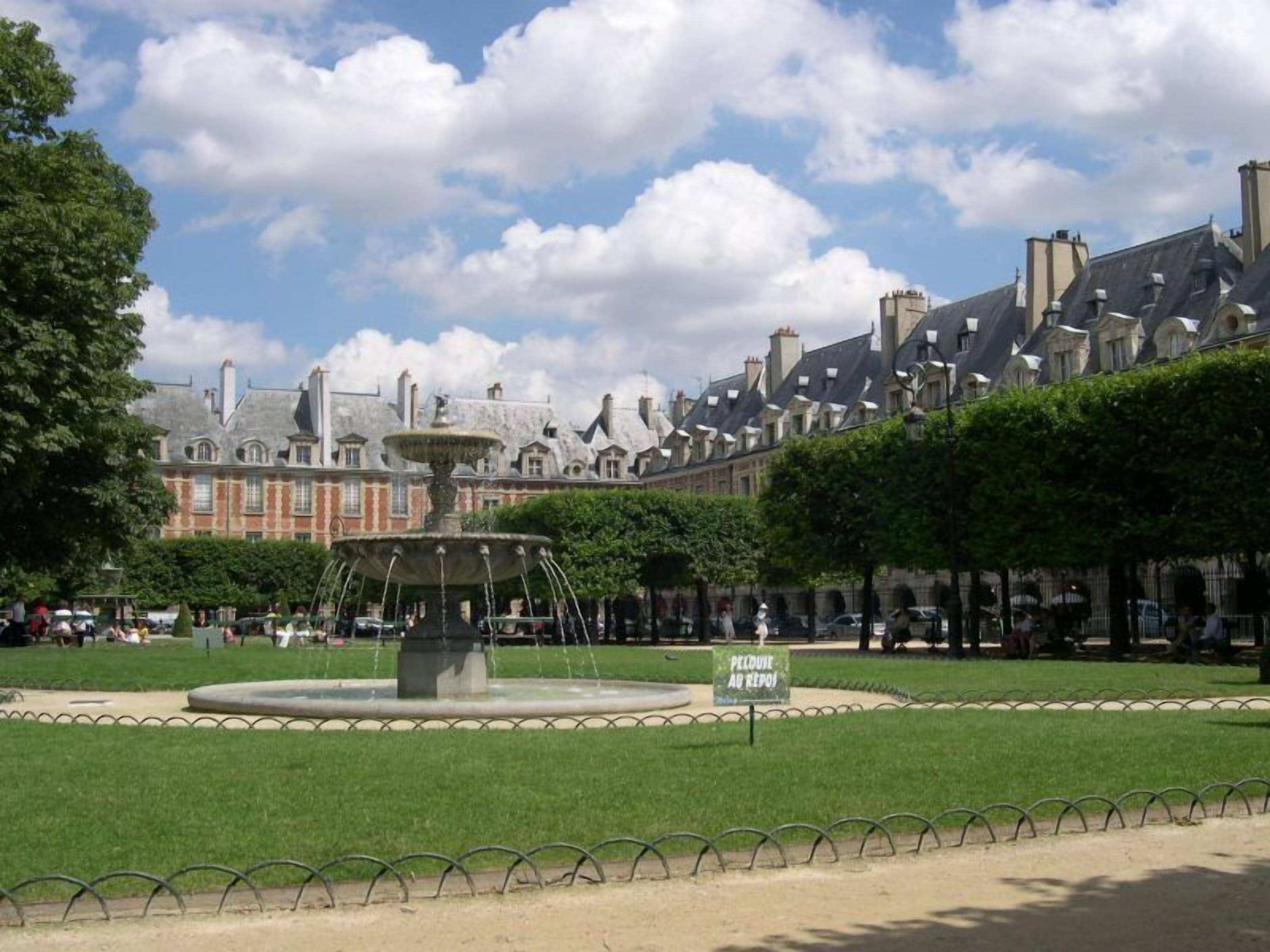 A historic building with a fountain in the courtyard.