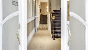 A hotel reception area with a marble staircase and a reception desk. - Hotel Courseine (Courbevoie)