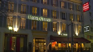 Hotel Claret with a classic facade, multiple windows, and illuminated signage. - Hôtel Claret Bercy (Paris)