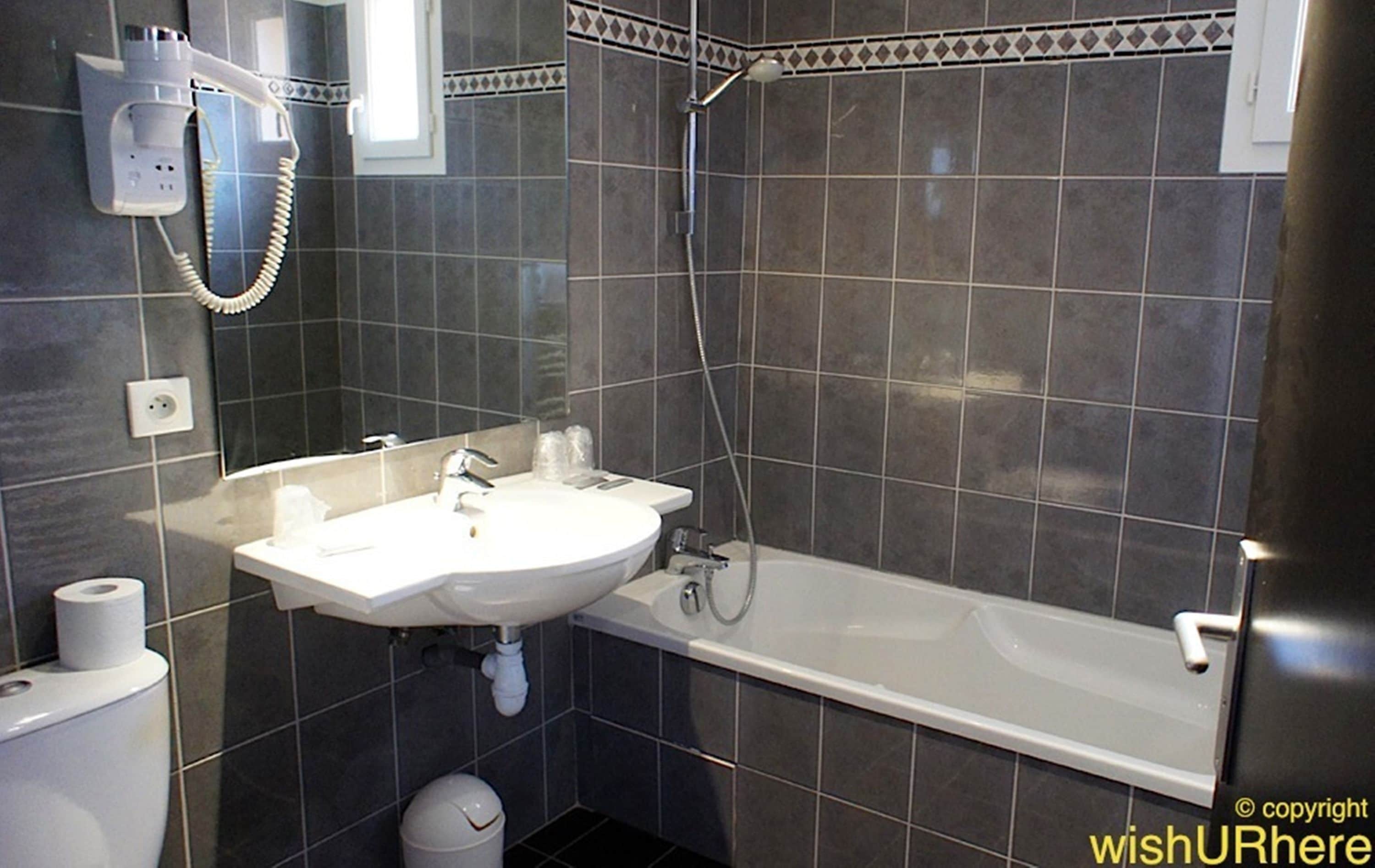 bathtub, free toiletries, hair dryer, towels