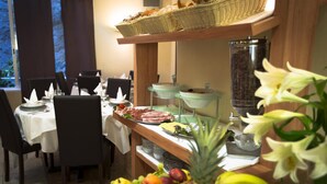 A breakfast buffet with various food items and a coffee station. - America Hotel Lourdes (Lourdes)