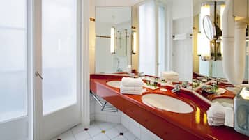 Un baño moderno con dos lavamanos, un espejo grande y una ducha.