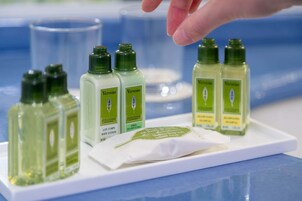 A display of Verveine body lotion bottles on a white tray.