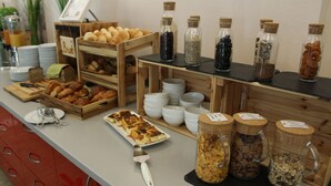 A breakfast buffet with various food items and condiments. - H+ Hotel Erfurt (Erfurt)
