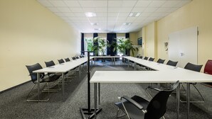 A conference room with a long table and chairs, a whiteboard, and a door. - Hotel Gertrudenhof (Cologne)