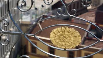 A metal balcony railing with a decorative flower design.