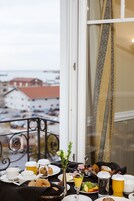 A breakfast table with various food items and a view of a snowy landscape through a window.