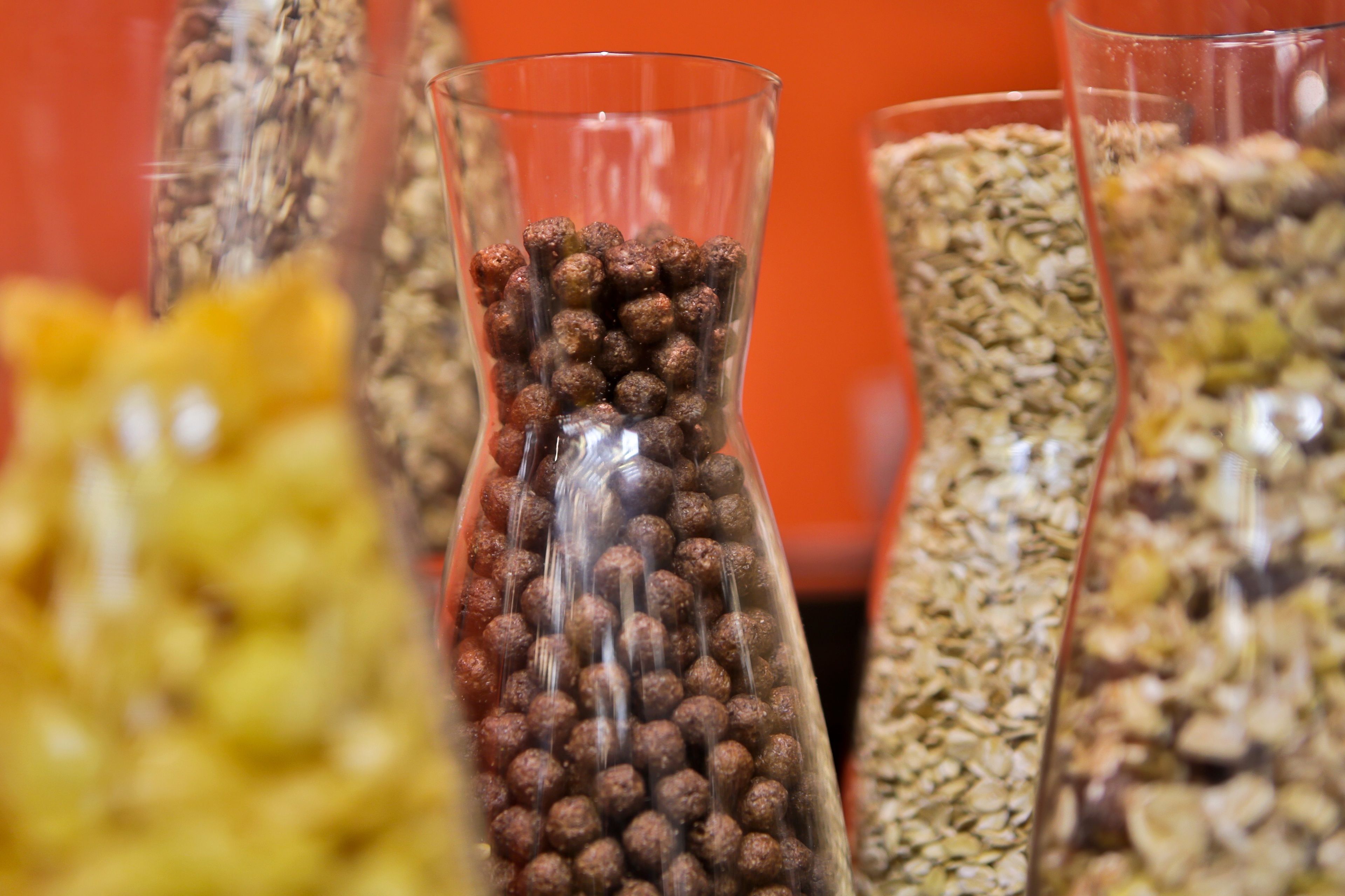 Three glass containers filled with different types of grains and seeds.