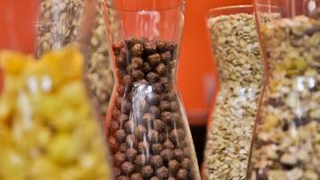 Three glass containers filled with different types of grains and seeds.