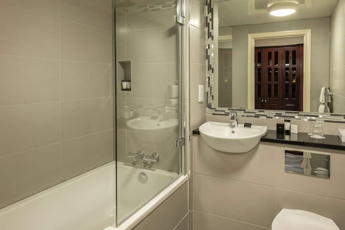 combined shower/bathtub, designer toiletries, hair dryer, towels