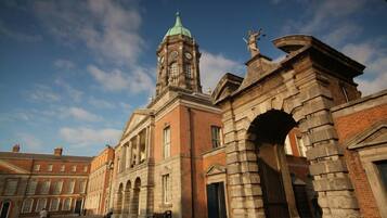 A historic building with a clock tower, arched entrance, and classical architecture.