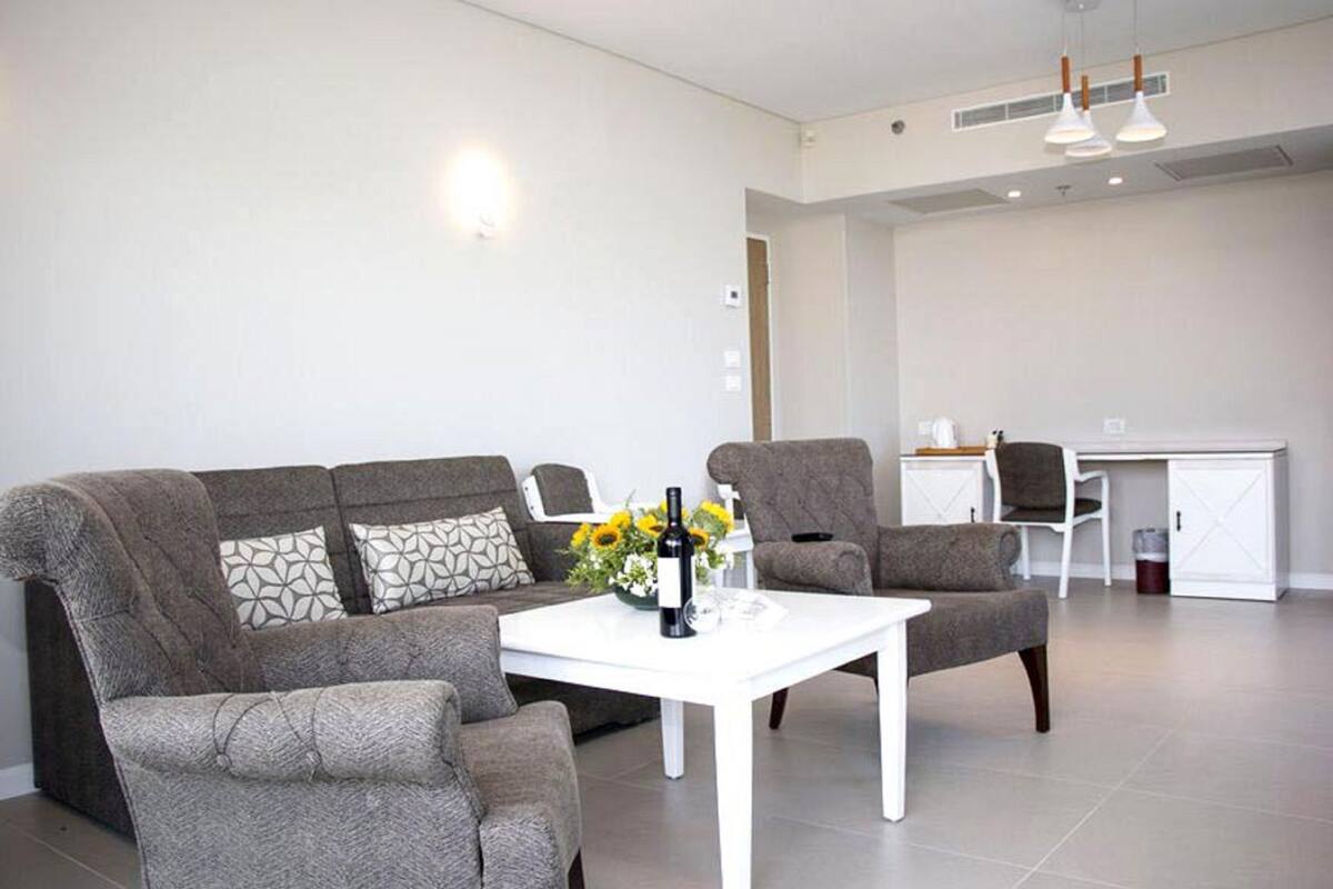 hod room with balcony | living room | flat-screen tv