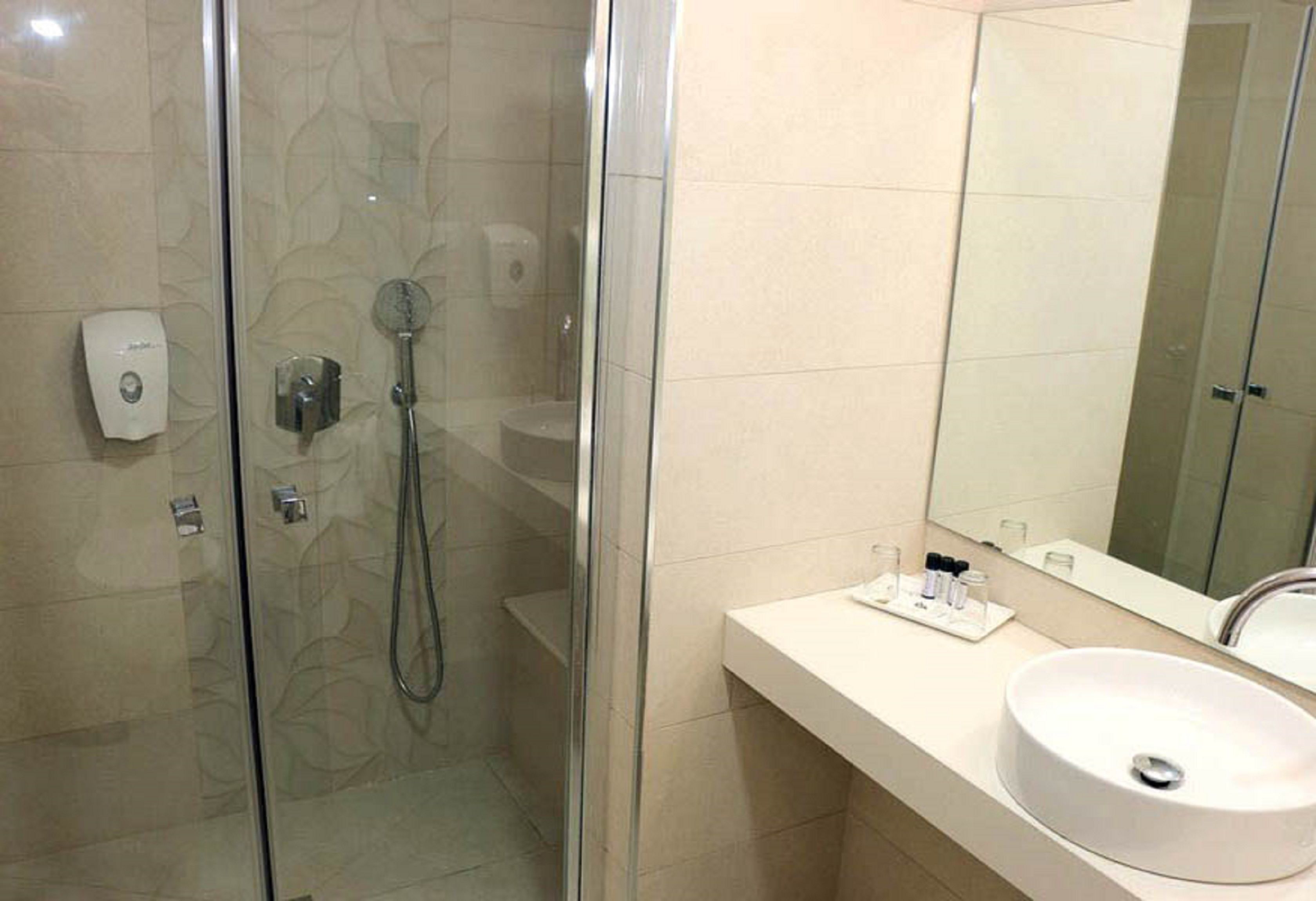 hod room with balcony | bathroom | combined shower/bathtub, hair dryer, towels