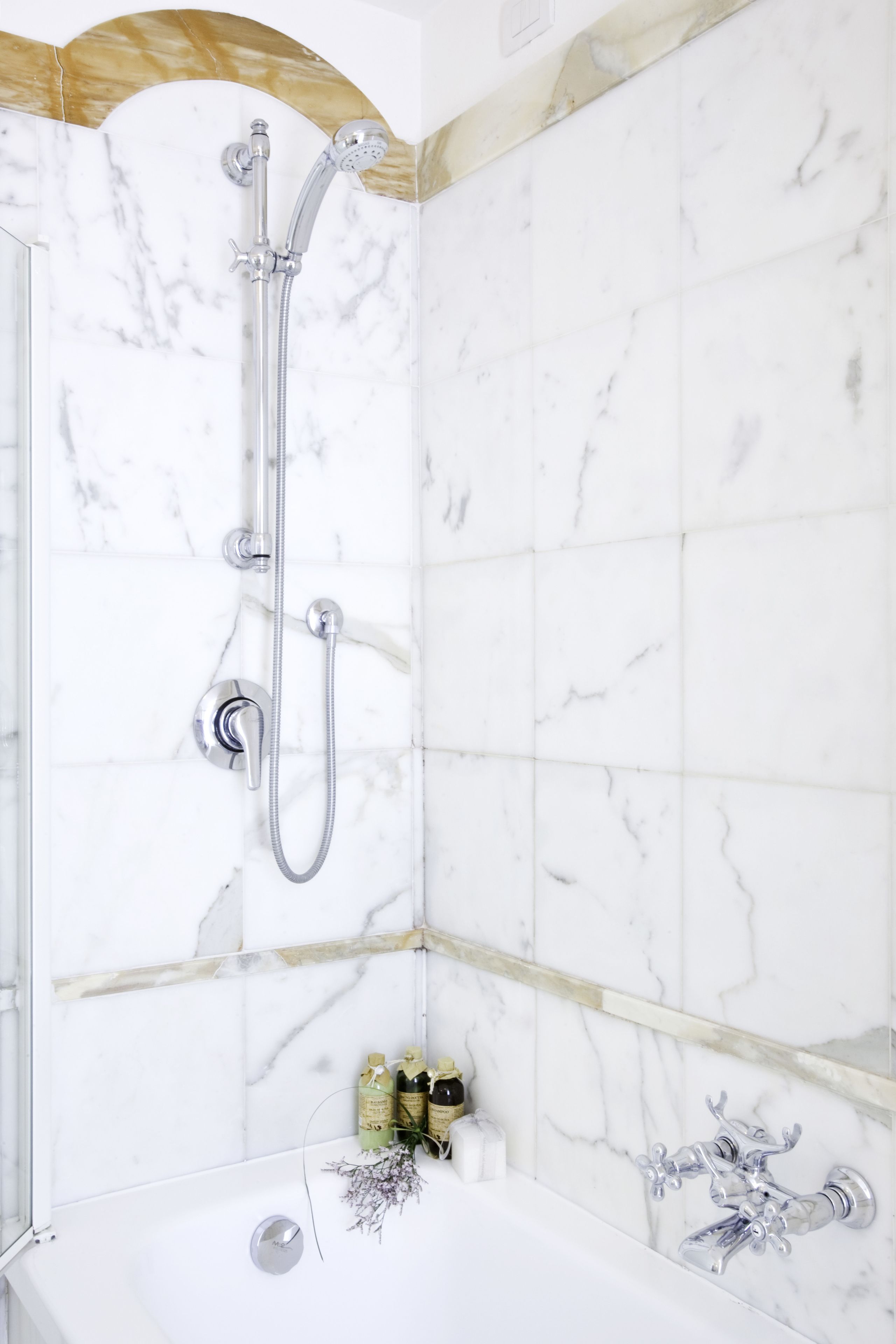 A bathroom with a shower, a bathtub, and a toilet.