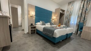 Une chambre moderne avec un grand lit, des lampes de chevet, un bureau et une chaise.