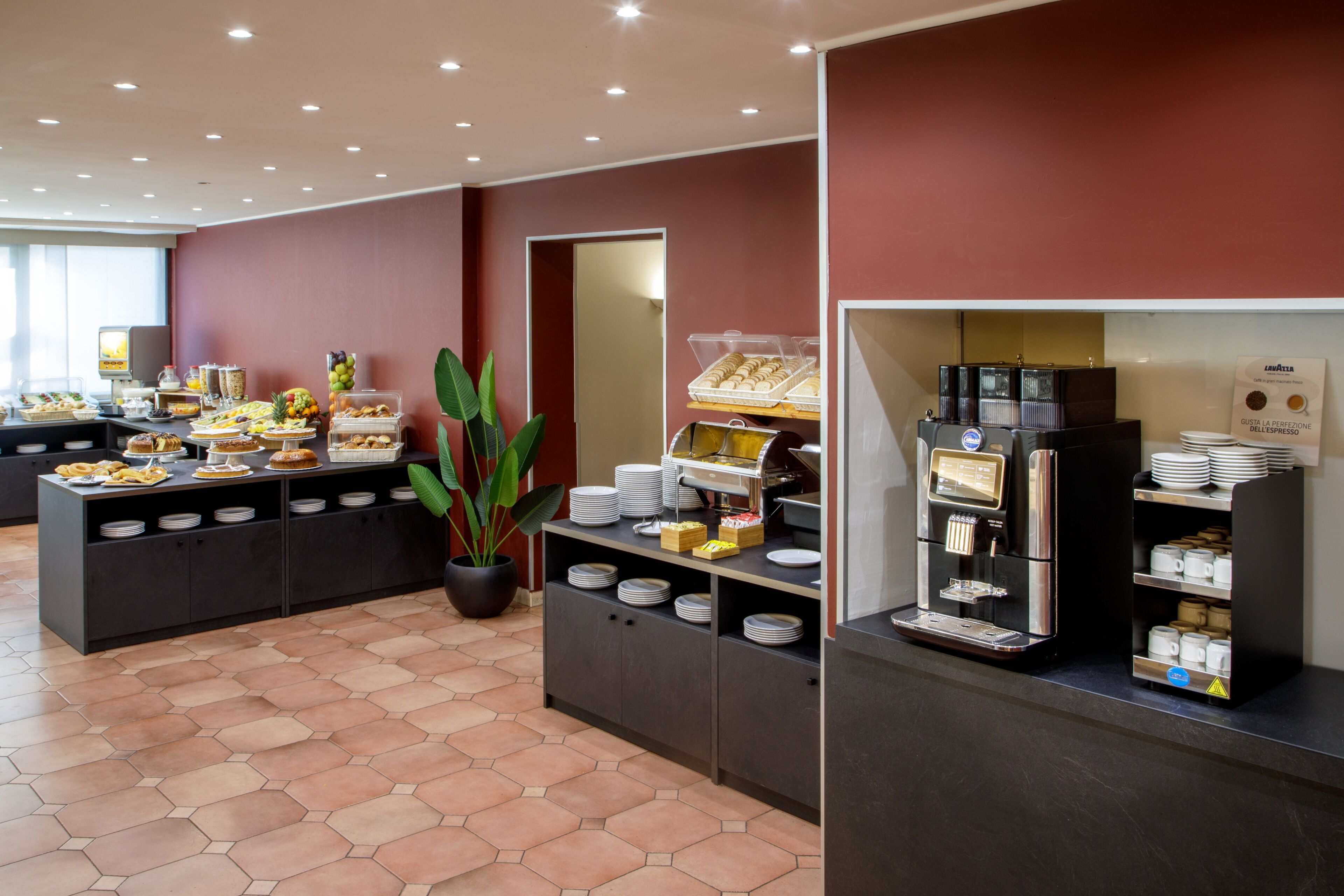 A buffet setup with various food items and a coffee machine.