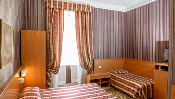 Triple Room | Minibar, in-room safe, desk, soundproofing