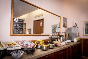 A buffet area with various food items and a coffee station.