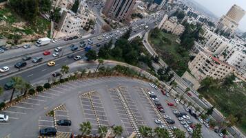 A multi-level parking structure with clear lane markings and a central island.