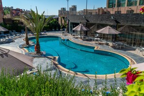 Seasonal outdoor pool, open 9:00 AM to 6:00 PM, pool umbrellas