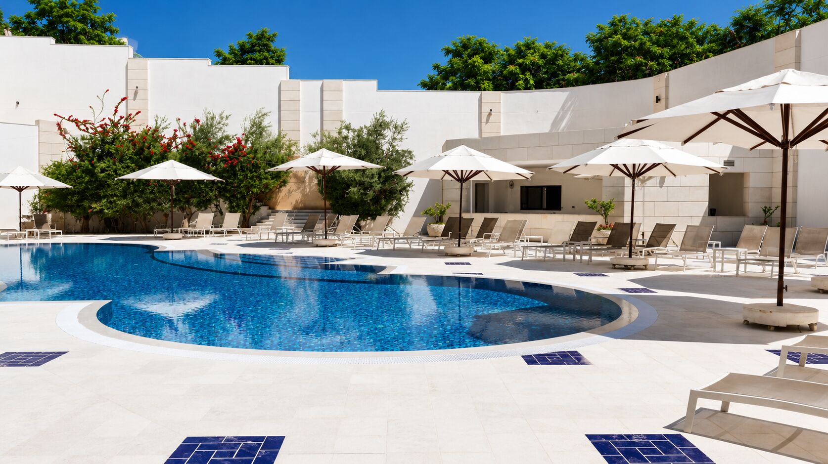Seasonal outdoor pool, open 9:00 AM to 6:00 PM, pool umbrellas