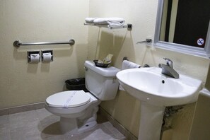 A standard bathroom with a toilet, sink, and towel rack. - Hotel Santa Irene (Guadalajara)