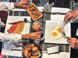 A table with various breakfast items including eggs, pastries, and a fruit platter. - Ibis Casa-voyageurs (Casablanca)