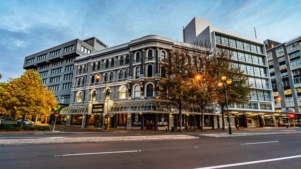 A historic building with a modern extension, featuring a classic facade and a contemporary glass structure. - Scenic Hotel Southern Cross (Dunedin)