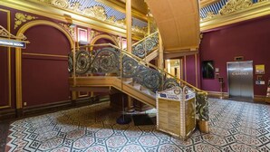 A grand staircase with ornate railings and a patterned floor, leading to a room labeled "CASINO". - Scenic Hotel Southern Cross (Dunedin)