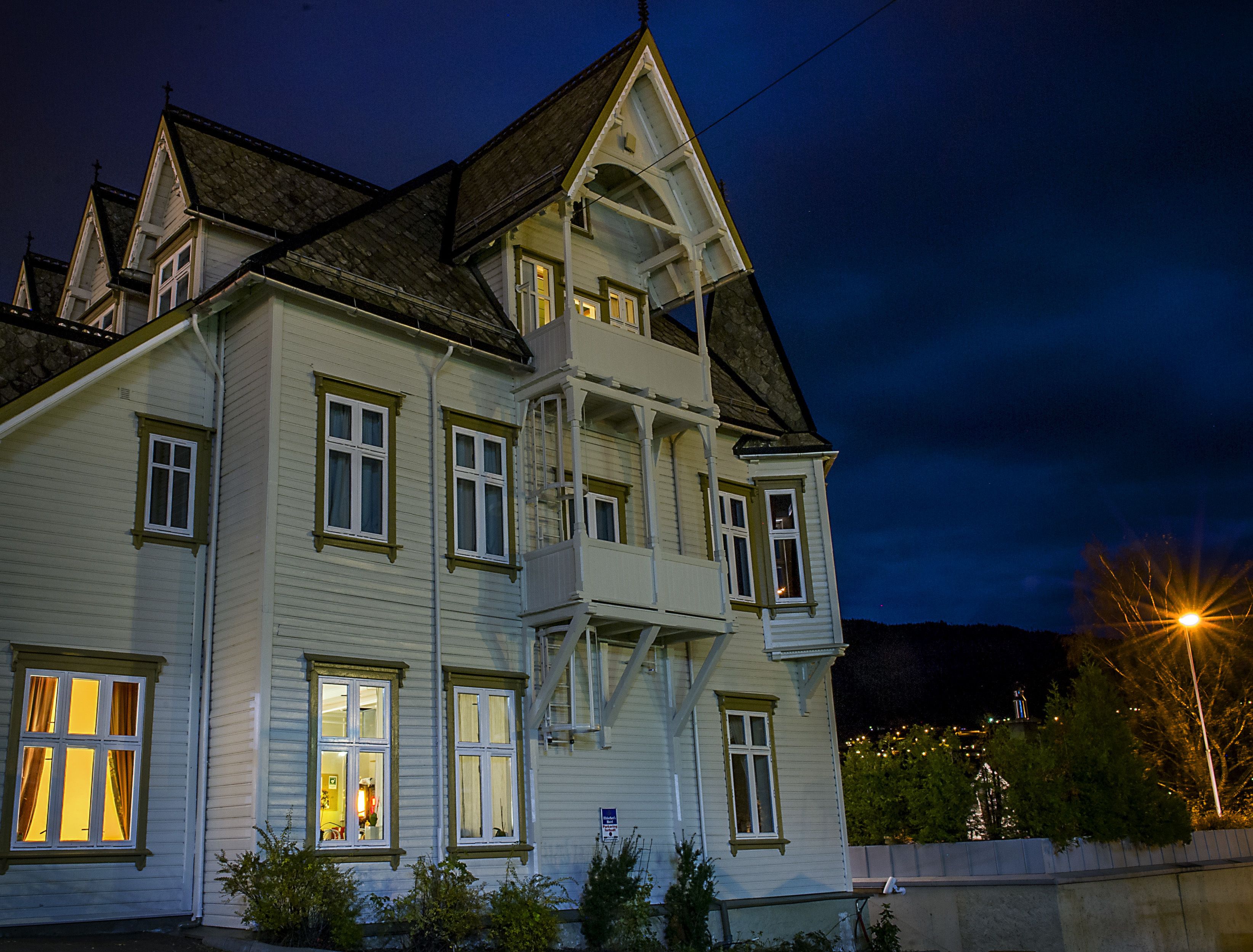 A large, multi-story building with a steep gabled roof and dormer windows.