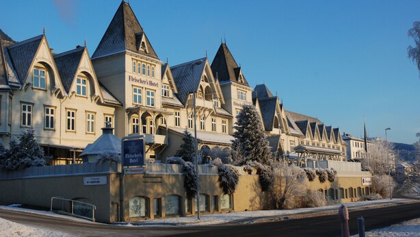 A historic hotel with a classic European architectural style, featuring multiple pointed roofs and a prominent entrance. - Fleischer's Hotel (Voss)