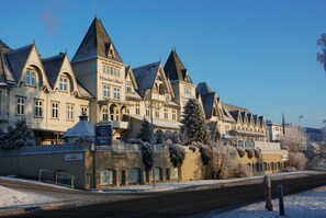 A historic hotel with a classic European architectural style, featuring multiple pointed roofs and a prominent entrance. - Fleischer's Hotel (Voss)