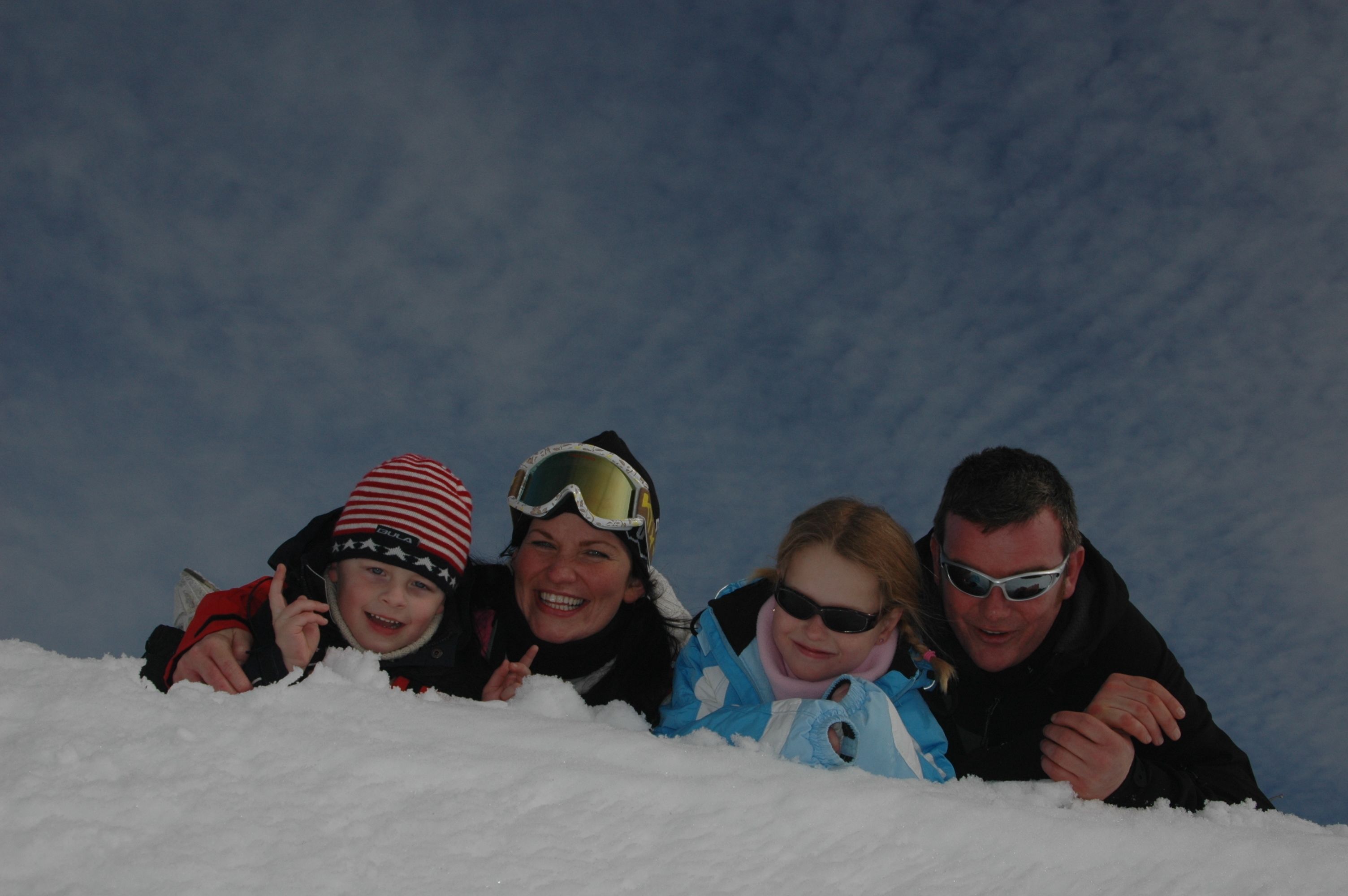 A group of people lying in snow.