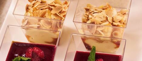 Four square dessert glasses with different toppings.