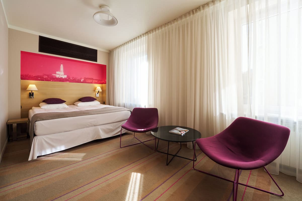 Hypo-allergenic bedding, desk, laptop workspace, blackout drapes