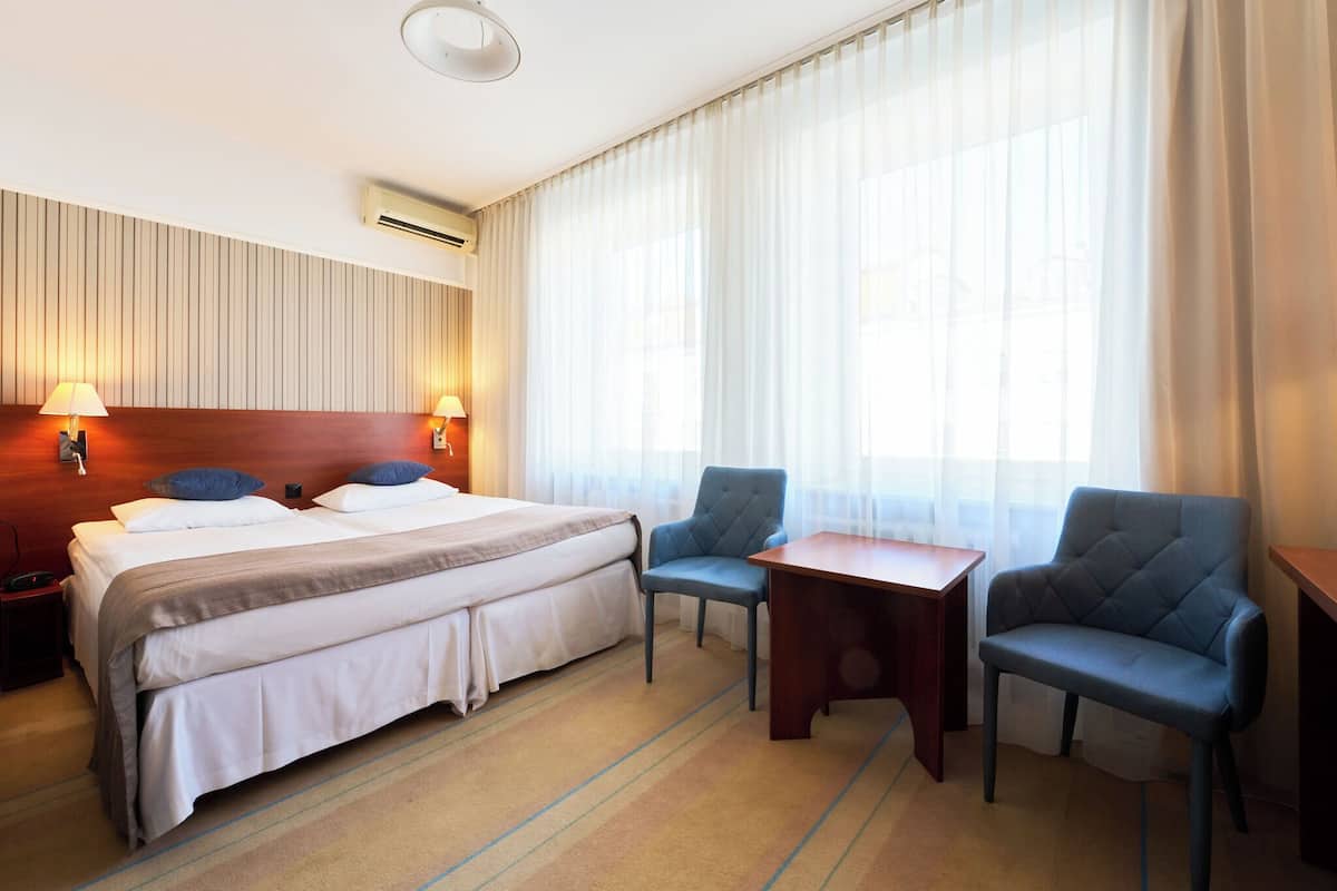 Hypo-allergenic bedding, desk, laptop workspace, blackout drapes