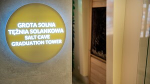 A sign with text in multiple languages indicating a location named "Salt Cave Graduation Tower." - Hotel Cristal (Bialystok)
