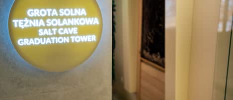 A sign with text in multiple languages indicating a location named "Salt Cave Graduation Tower."